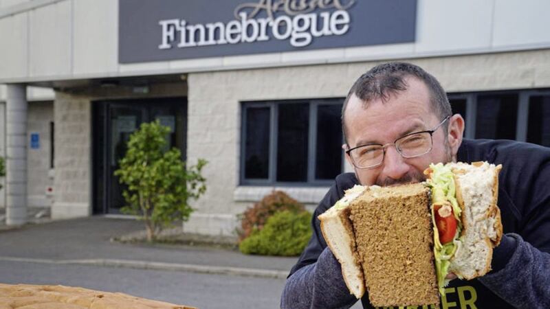 Sean Kearney of Finnebrogue enjoying the first bite of the record breaking burger 