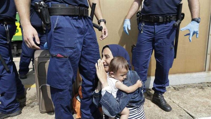 A migrant is detained in Bicske, Hungary, yesterday.  Picture by Petr David Josek/AP Photo              