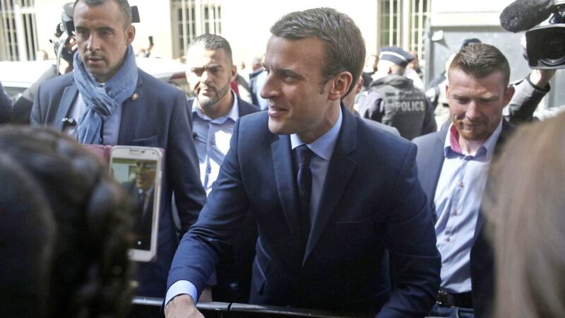 French centrist presidential candidate Emmanuel Macron leaves his apartment, in Paris yesterday. French voters shut out the political mainstream from the presidency for the first time in modern history, and yesterday found themselves being courted for the runoff election between populist Marine Le Pen and centrist Emmanuel Macron PICTURE: Thibault Camus/AP 