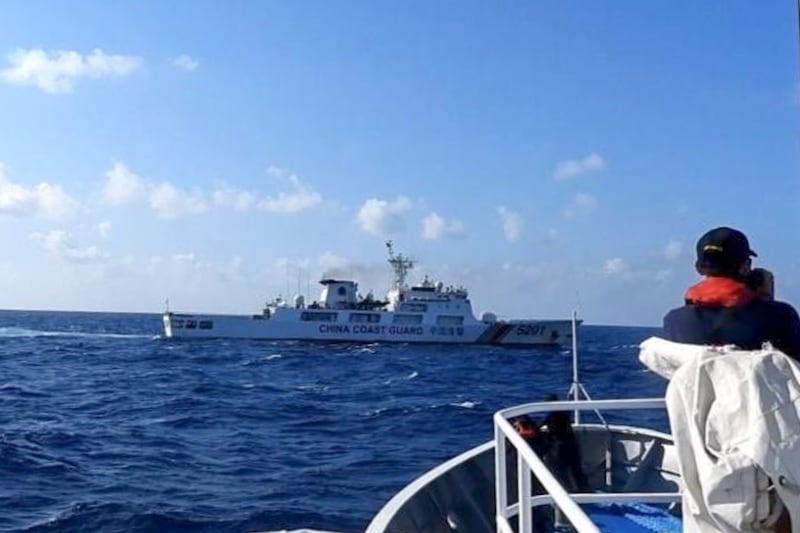 In this photo provided by the Philippine Coast Guard, a Chinese coast guard ship, top, tries to block a Philippine government vessel in the disputed South China Sea (Philippine Coast Guard via AP)
