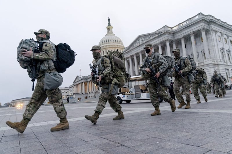 National Guard soldiers walk out of the U.S. Capitol, on Saturday as security is increased ahead of the inauguration of President-elect Joe Biden and Vice President-elect Kamala Harris. Picture by Jacquelyn Martin, Associated Press 