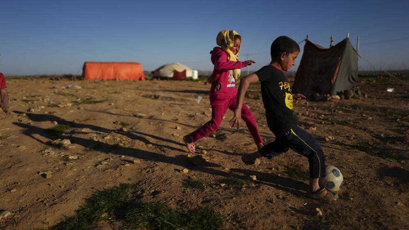 Syrian refugee children play at a camp in Jordan. Around 60 refugees are to arrive in Northern Ireland next month. Picture by Muhammed Muheisen, AP  