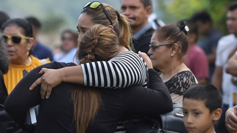 Family and friends of Alberto Antonio Palacios, one of the football fans who died in the recent stampede, mourn during his funeral in San Salvador (AP Photo/Salvador Melendez)