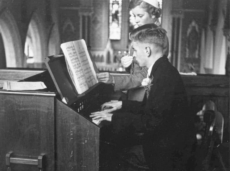 Gerry, aged 17, plays the church organ at his sister June&#39;s wedding in 1952 , assisted by younger sister Andra turning the pages 