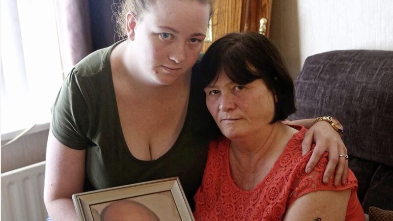 Teresa Carter with her daughter, Georgina, with a photograph of her 31-year-old son, Anthony who died suddenly from heart failure. Photo by Hugh Russell 