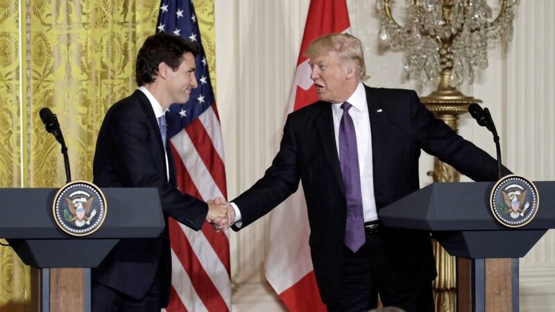 President Donald Trump shakes hands with Canadian Prime Minister Justin Trudeau during their joint news conference in the East Room of the White House in Washington yesterday PICTURE: Evan Vucci/AP 