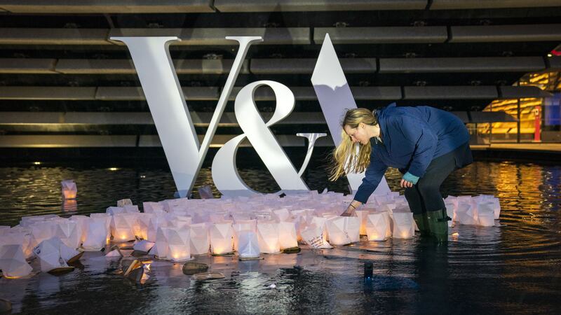 Artist Kate Colin with hundreds of ‘birthday wishes’ floating on the water pools outside V&A Dundee (Jane Barlow/PA)