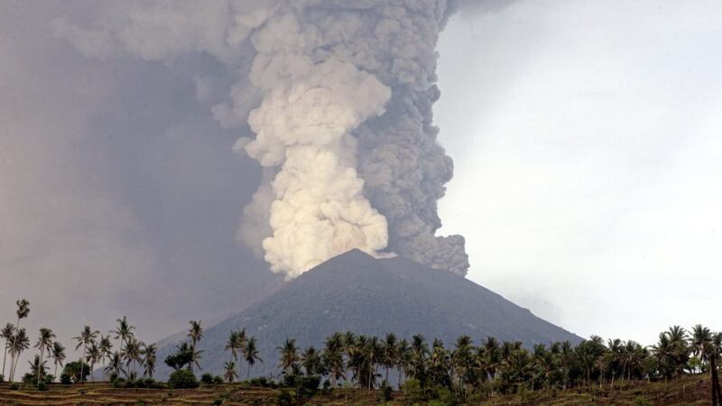 A view of the Mount Agung volcano erupting in Karangasem, Bali, Indonesia, Monday, Nov. 27, 2017. The volcano on the Indonesian tourist island of Bali erupted for the second time in a week on Saturday, disrupting international flights even as authorities said the island remains safe. (AP Photo/Firdia Lisnawati 