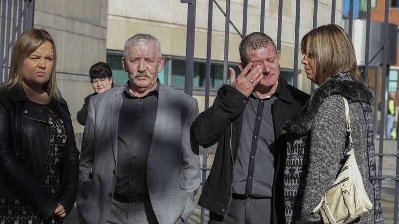 Daniel McColgan's brother Eamon weeps outside Laganside court standing with Daniel's father Uel and his partner at the time of his murder Lyndsey Millliken (left). Picture by High Russell