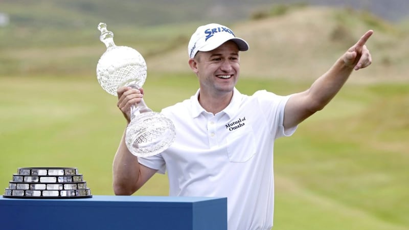 Scotland&#39;s Russell Knox celebrates with the trophy after winning the Dubai Duty Free Irish Open at Ballyliffin 