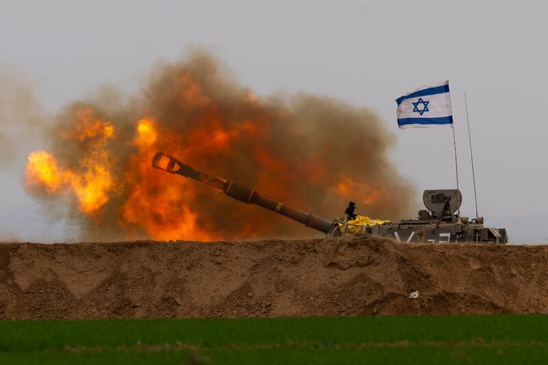 An Israeli mobile artillery unit fires a shell from southern Israel towards the Gaza Strip, in a position near the Israel-Gaza border on Thursday (Ohad Zwigenberg/AP)