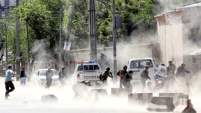 Security forces run from the site of a suicide bombing in Kabul Picture by Massoud Hossaini/AP 