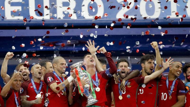 Portugal's Cristiano Ronaldo and Pepe hold the trophy at the end of the Euro 2016 victory over France at the Stade de France in Saint-Denis<br />Picture by AP