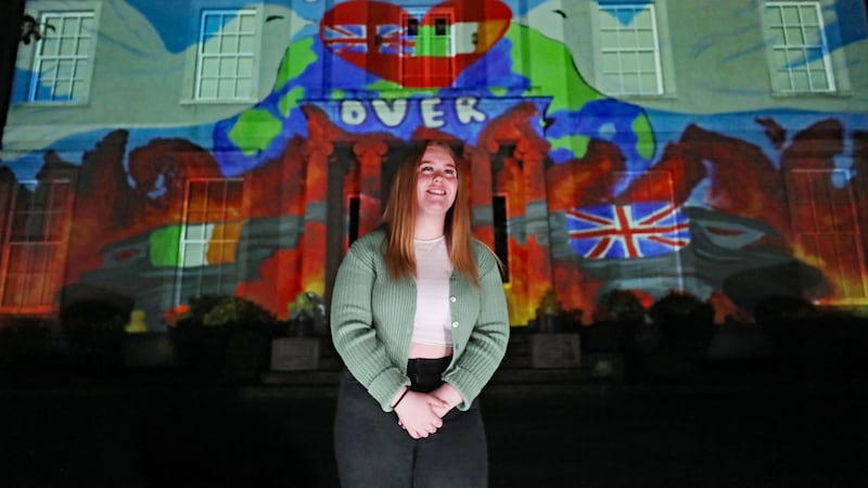 Faith Lyttle with her artwork projected onto Hazelwood Integrated College in Belfast as part of the Herstory Parallel Peace Project. Picture by Niall Carson/PA Wire&nbsp;