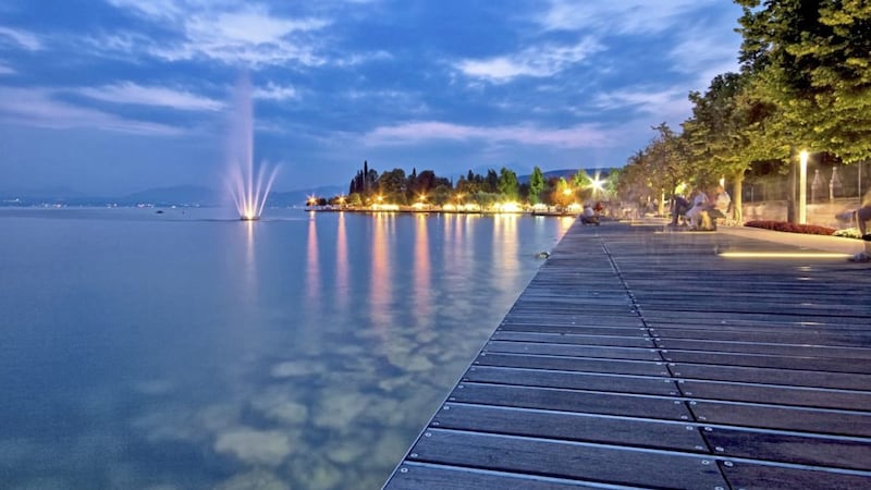 The wooden walkway by Lake Garda, Bardolino, is popular for a stroll as well as with cyclists 