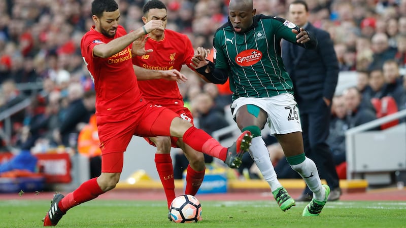&nbsp;Liverpool's Trent Alexander-Arnold (centre) and Liverpool's Kevin Stewart (left) battle for the ball &nbsp;with Plymouth Argyle's Paul Arnold Garita