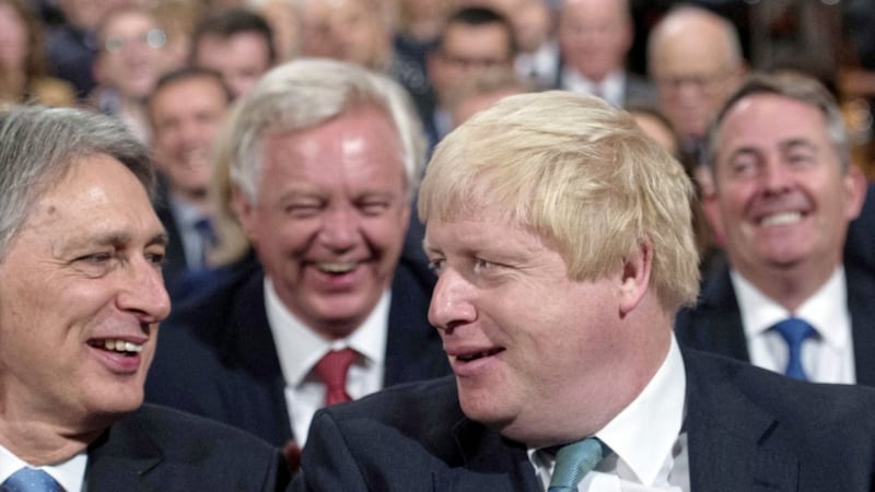 It&#39;s no laughing matter, as former foreign secretary Boris Johnson, pictured left, and chancellor Philip Hammond, pictured right, share a joke while former Brexit secretary looks on 