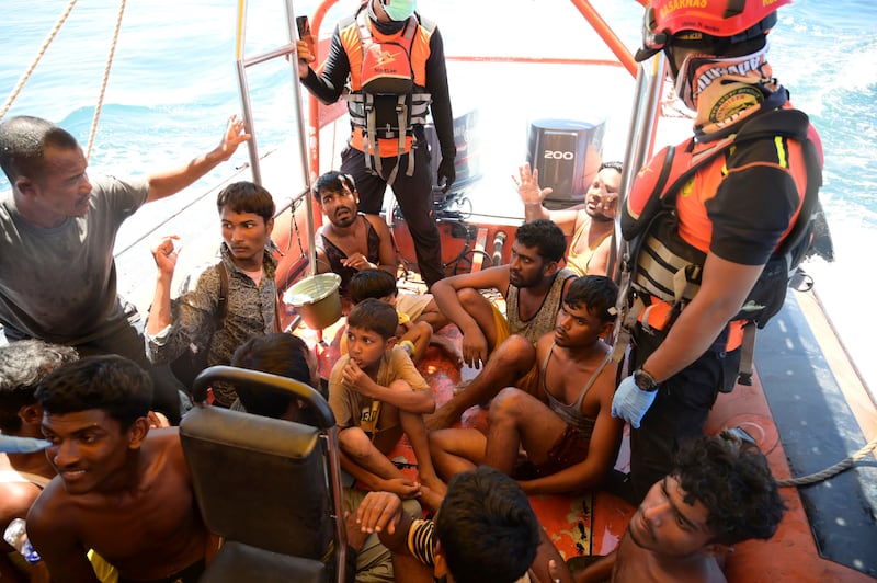 Rohingya refugees rescued from their capsized boat sit in a National Search and Rescue Agency boat (Reza Saifullah, AP)