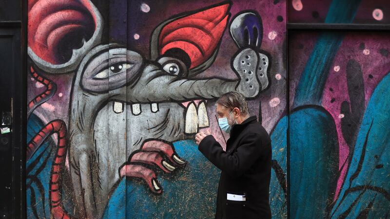 A man wears a face mask as he passes a mural  in Leicester during England's third national lockdown to curb the spread of <span class="red">coronavirus</span>. Picture by Mike Egerton/PA Wire