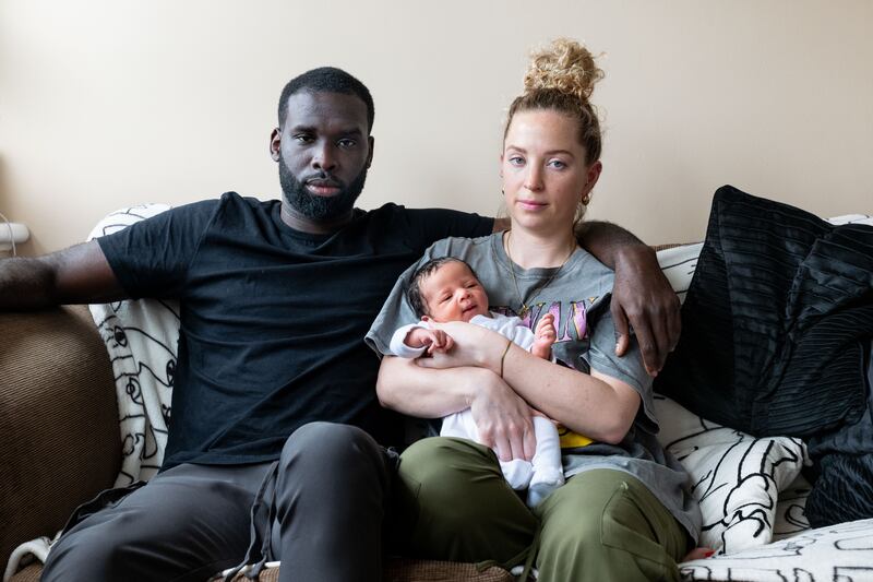 Quincy Rowe and his partner Natasha Paine with their two and a half week old son Jaxxon (Windrush: A Voyage through the Generations/Jim Grover/PA)