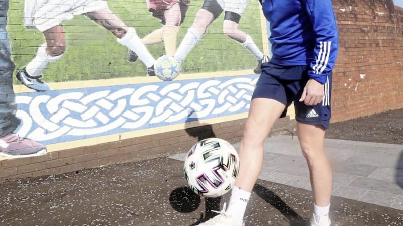 Marissa Callaghan kicking ball beside a gable wall in Albert Street on the Lower Falls Road Picture: Hugh Russell 