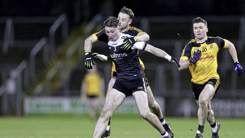 Kilcoo's Ryan McEvoy is put under pressure from Gareth Mannion of Ramor United during the AIB Ulster Club SFC quarter-final at Kingspan Breffni Picture: Inpho