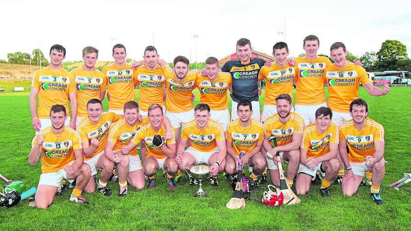 The Antrim players celebrate with trophy following their five-point win. Picture by Margaret McLaughlin 