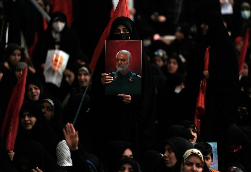 A woman holds up a poster of Qassem Soleimani during a commemoration in Tehran (Vahid Salemi/AP)
