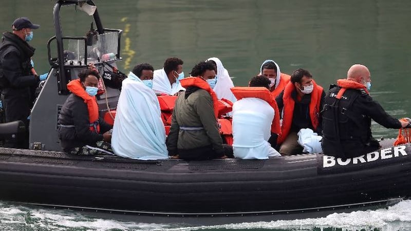 &nbsp;A group of people, thought to be migrants, are brought to shore at Dover in Kent by Border Force officers on August 15 2020. Picture by Gareth Fuller, PA Wire