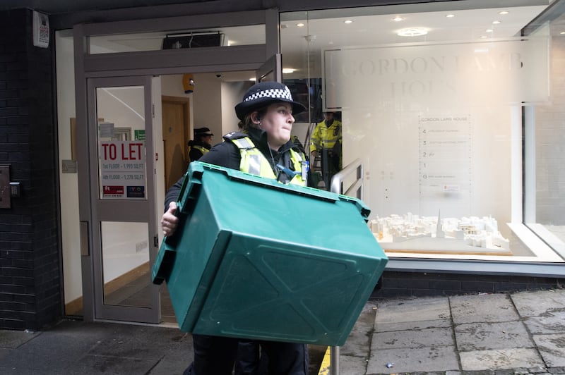 A police officer removing material from SNP headquarters in Edinburgh last April
