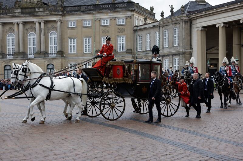 Denmark’s Queen Margrethe II is escorted by the Guard Hussar Regiment’s Mounted Squadron in the gold carriage from Amalienborg Castle to Christiansborg Castle (Nicolai Lorenzen/Ritzau Scanpix via AP)