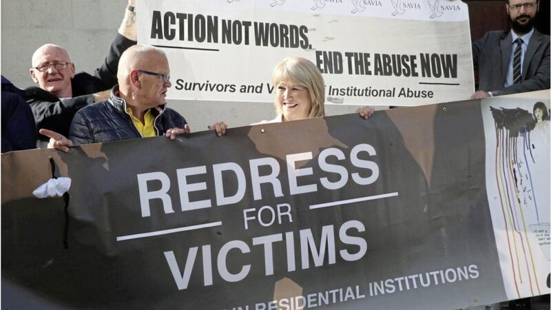 Margaret McGuckin of Survivors and Victims of Institutional Abuse (Savia) protests outside the High Court in Belfast 