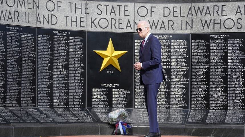 President Joe Biden places a wreath at Veterans Memorial Park at the Delaware Memorial Bridge in New Castle, Delaware (Patrick Semansky/AP)