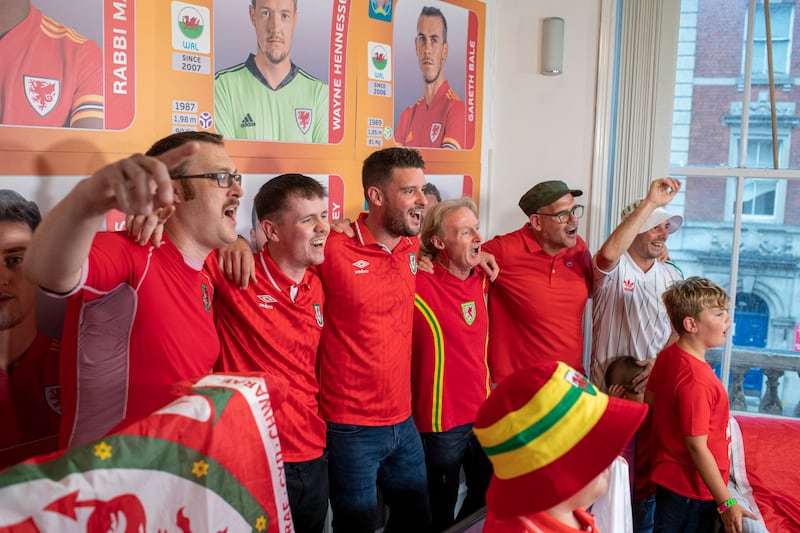 Gol Cymru founder Tim Hartley (third from right) joins in singing the chorus. (Andrew Dowling)