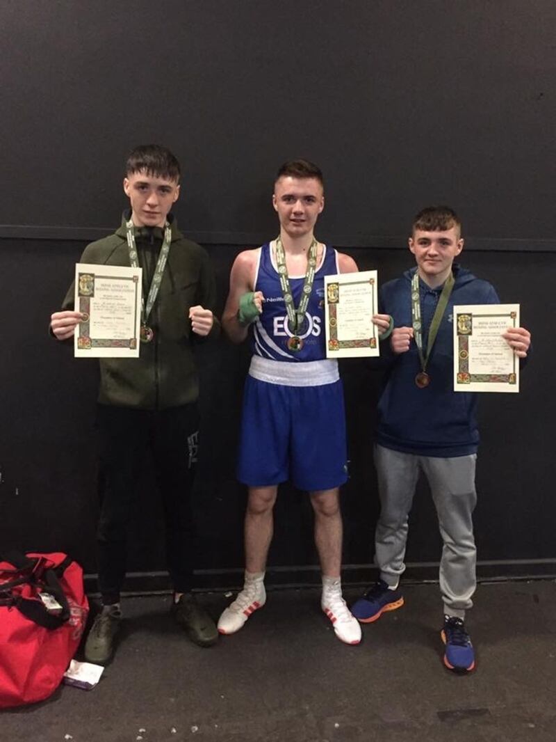Brother Jake (left) and Kane Tucker with Holy Trinity club-mate Barry McReynolds after Saturday's Irish title successes