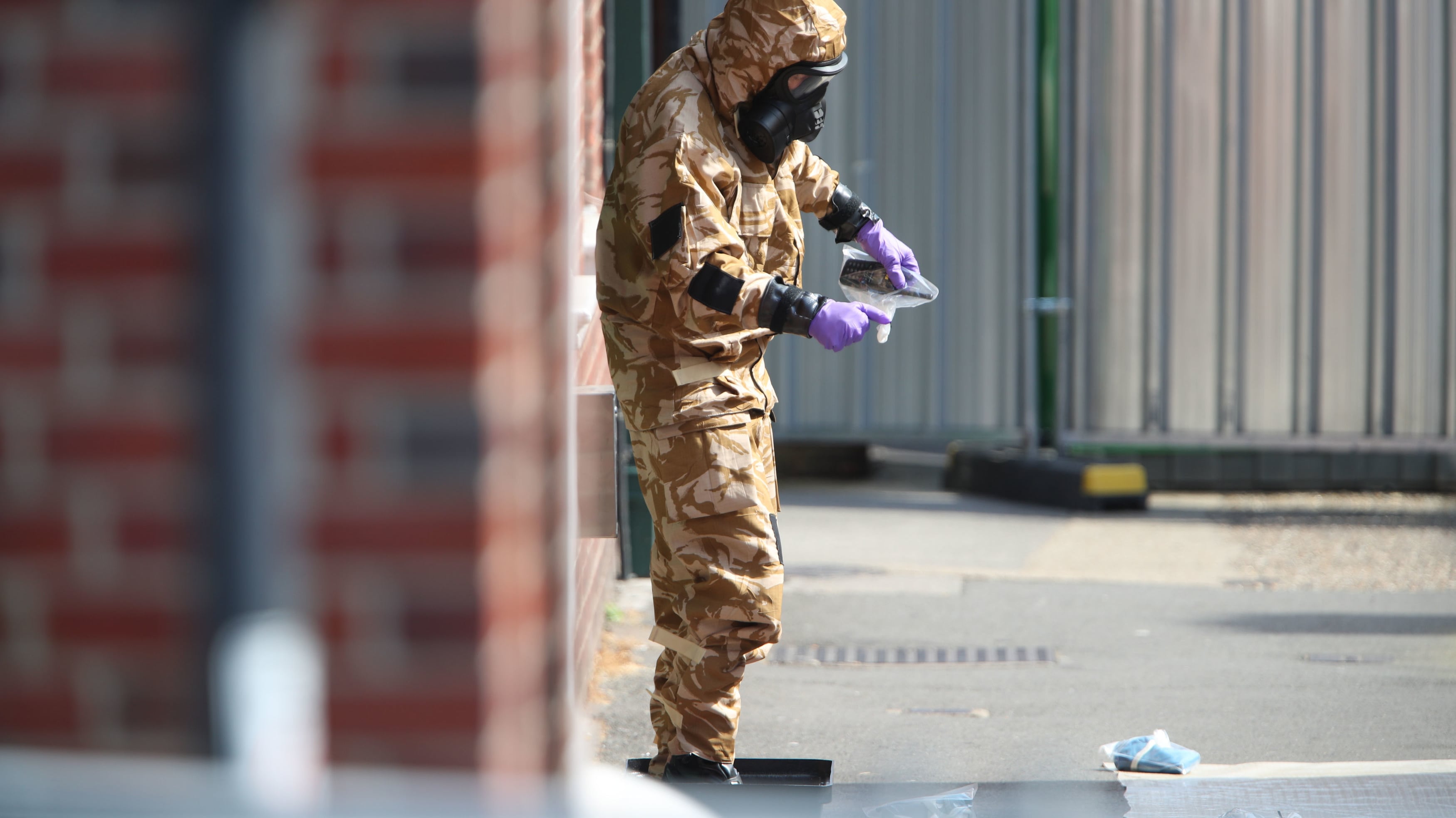 An investigator in a chemical suit