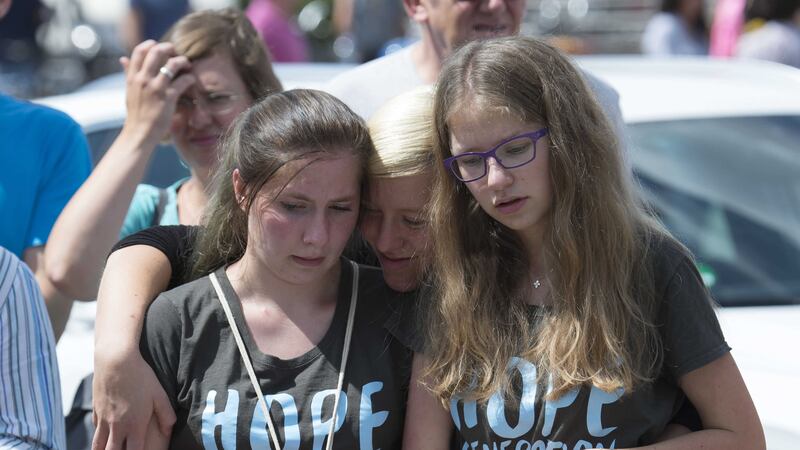People mourn beside the Olympia shopping center where a shooting took place leaving nine people dead in Munich, Germany. Picture by Jens Meyer, Associated Press&nbsp;