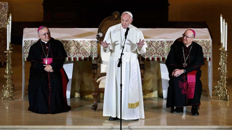 Archbishop Charles Chaput (left) and Bishop Timothy Senior (right) listen as Pope Francis addresses a gathering in Saint Martin's Chapel