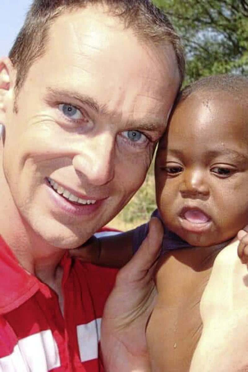 Frank Diamond pictured with baby Cosmos, whom he baptised in Africa. The pair share a birthday. 