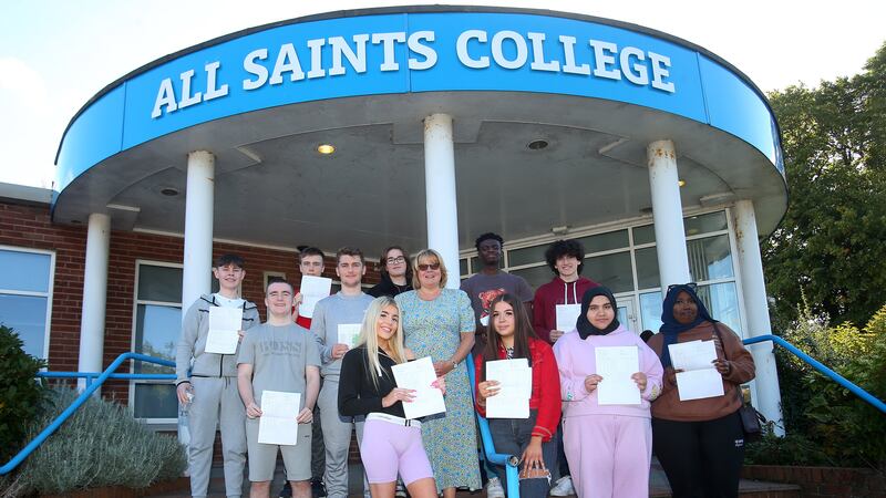 Principal of All Saints College in west Belfast Bronagh Farrimond pictured with a group of pupils who recieved their GCSE results today. PIcture by Mal McCann.