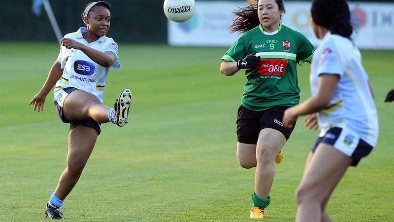 University College Dublin's Doris Oblalor (from Nigeria) is closed down by Queen's University Belfast's Yusi Zhou (from China) during an exhibition ladies' football match at Queen's Sport in Belfast <br />Picture: Paul McErlane