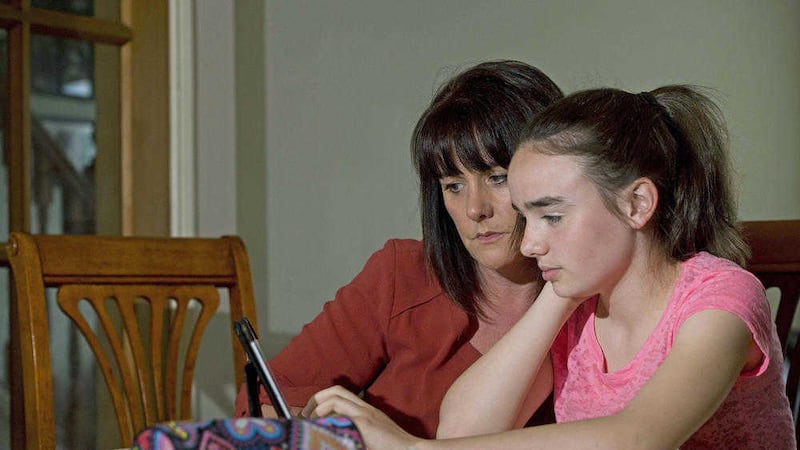 Niamh Dawson (14) and her mum, Jane, feel it is easy to get distracted when using an iPad for homework. Picture by Mark Marlow 