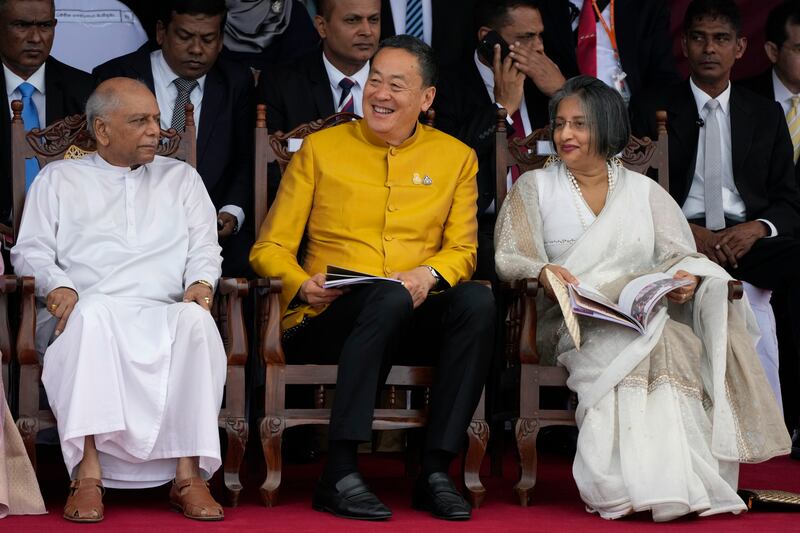 Thai Prime Minister Srettha Thavisin, centre, with Sri Lankan counterpart Dinesh Gunawaradane, left, and the First Lady of Sri Lanka Maithree Wickremesinghe during independence day commemorations (Eranga Jayawardena/AP)