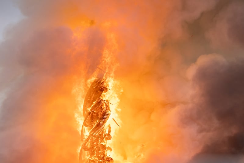 Fire rages from the dragon spire of the Stock Exchange in Copenhagen, Denmark (Ida Marie Odgaard/Ritzau Scanpix via AP)