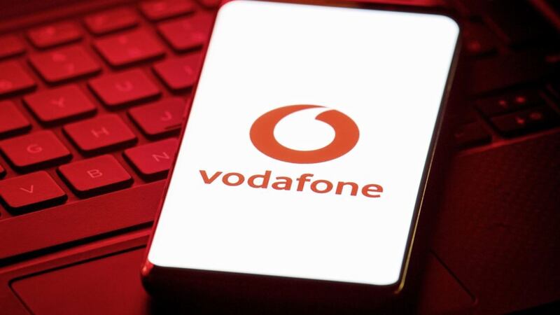 Vodafone has swung to a &euro;7.6 billion euro bottom line annual loss and slashed its shareholder dividend payout, its latest results show 