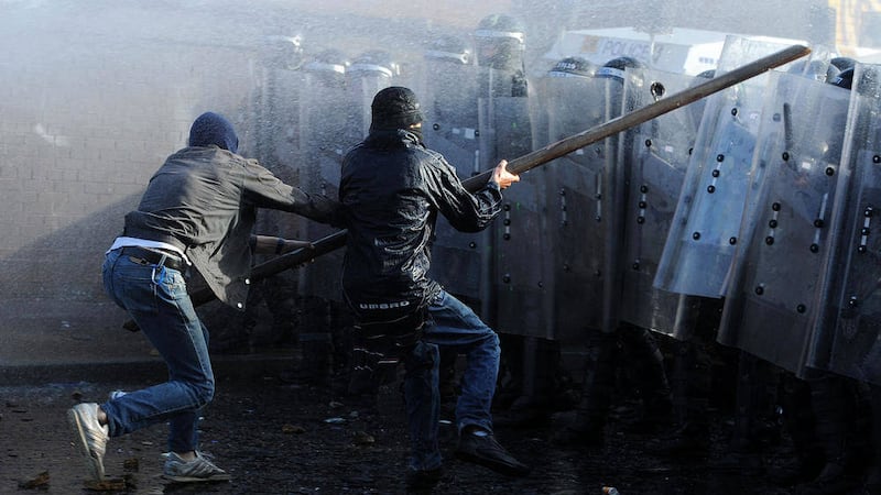 Rioters attack police with an iron bar during trouble in Ardoyne on July 12 2011. Picture by Justin Kernoghan 