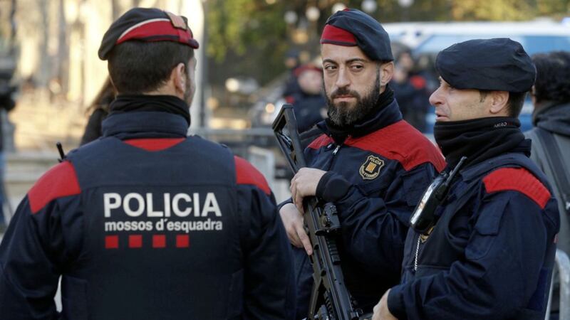 Catalan police officers stand guard at a check point outside the regional parliament, in Barcelona Picture by Manu Fernandez 