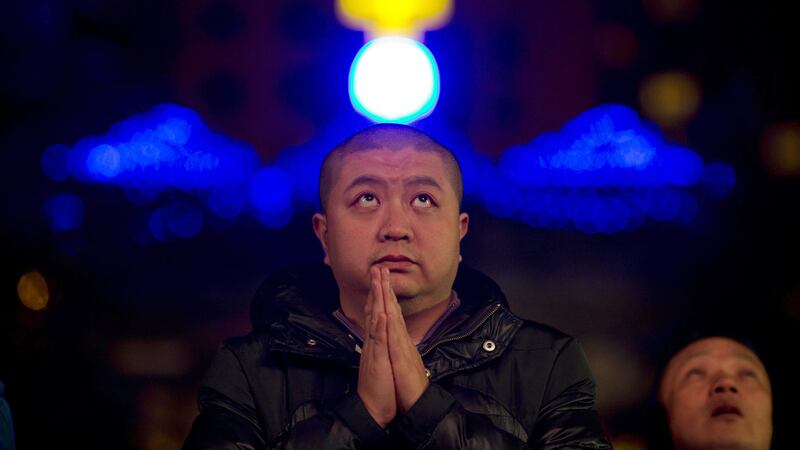 A man prays during Mass on Christmas Eve at the South Cathedral official Catholic church in Beijing. Picture by&nbsp;Ng Han Guan by AP&nbsp;