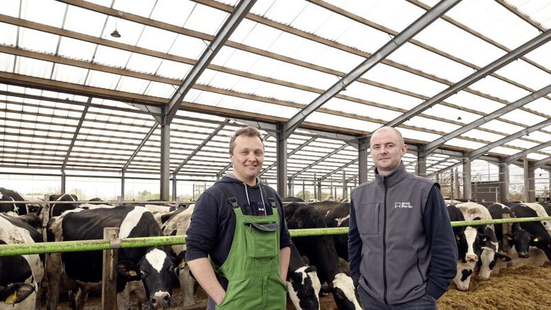 Dairy farmer George Bingham talks with Chris Chambers of Brett Martin about the positive impact of the new roofing on his herd. They are pictured on the Bingham dairy farm in Co Antrim 