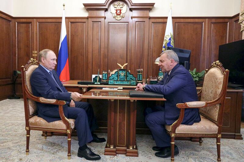 Russian President Vladimir Putin, left, listens to Yuri Borisov, the new CEO of the Russian State Space Corporation Roscosmos, at the Kremlin in Moscow